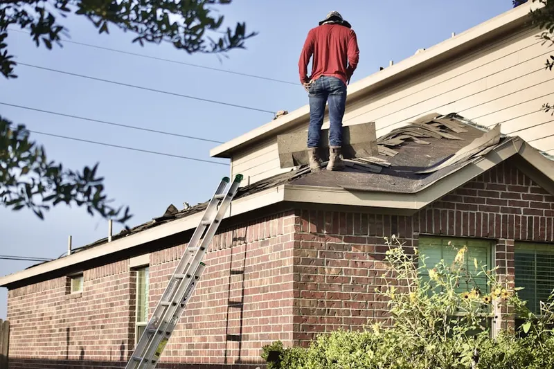 Professional roofer working on a residential roof in North Sarasota